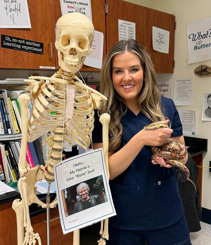Andrea poses with a science classroom anatomical skeleton
