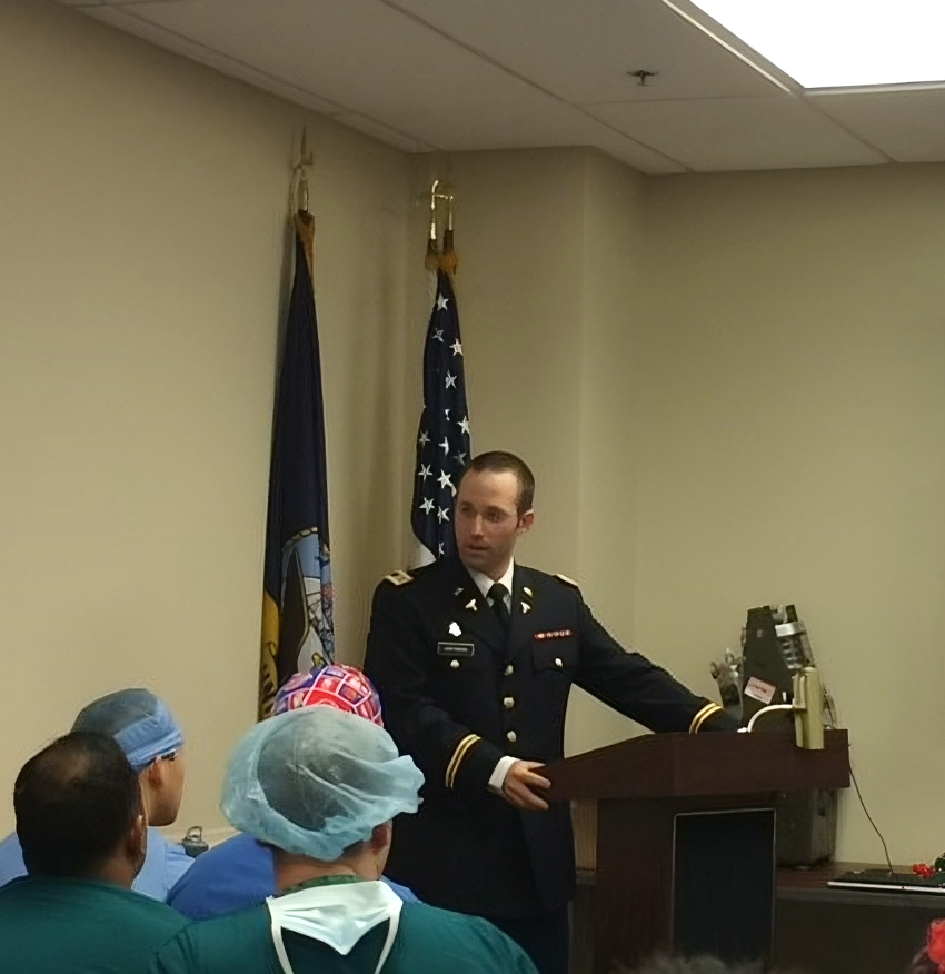 "Hoffmann giving a speech at a podium in military uniform"