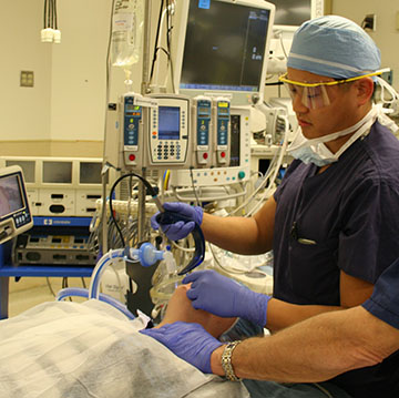 "A medical professional administering anesthesia to a patient"