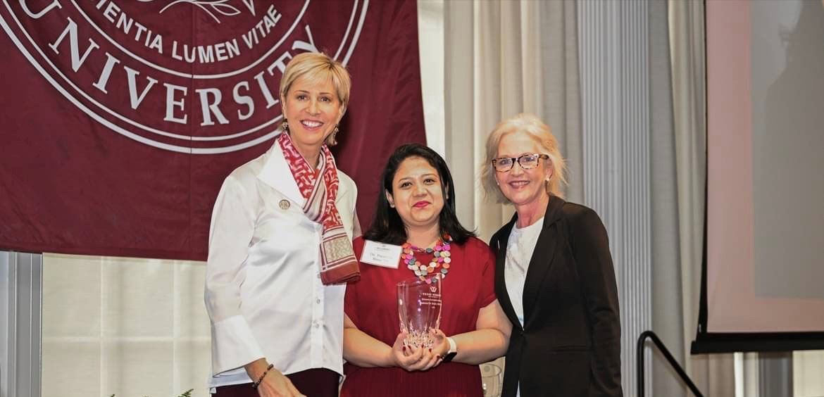 Dr. Basu receiving her award at TWU