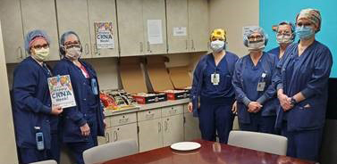 "CRNAs at UPMC Magee-Women's Hospital pose in a group in a break room"