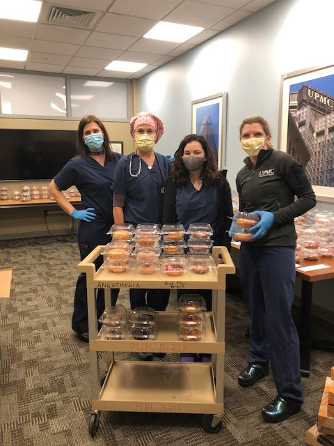 "UPMC Presbyterian CRNAs pose with a card full of donuts"