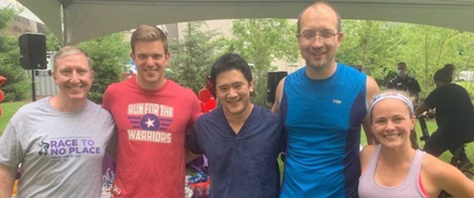 "Five department members pose for a photo outside at the race"