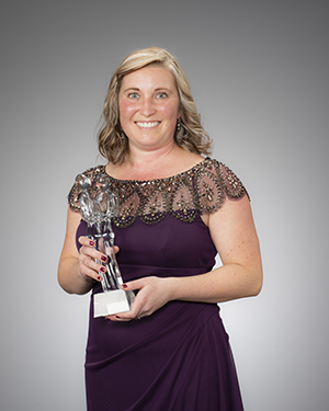 "Kristy Parrish in formal wear posing with the award"