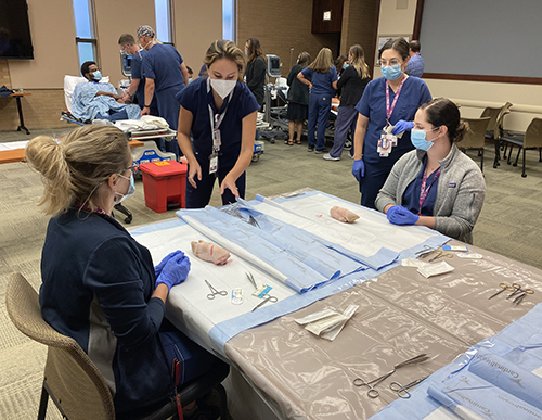 "Meghan Ehko giving a demonstration on suturing"