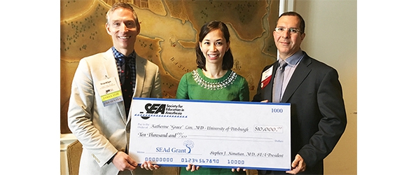 "Doctor Grace Lim posing with large check"
