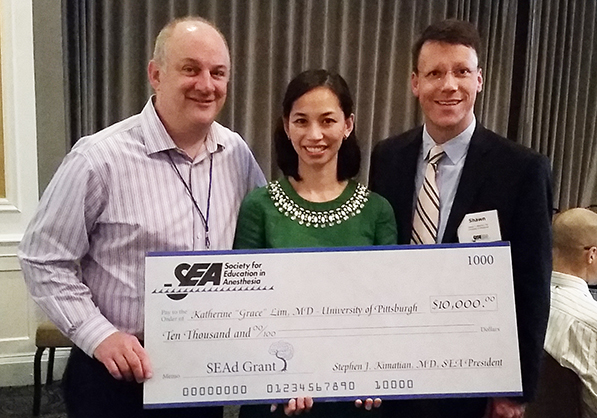 "Doctor Grace Lim posing with large check"