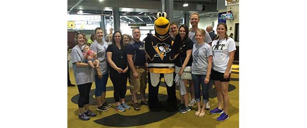 "CRNAs and SRNAs pose with the Pittsburgh Penguins mascot"