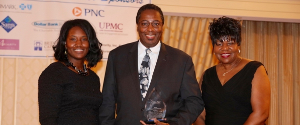 "Doctor Simmons posing with award, with Jerry Allen and her daughter"