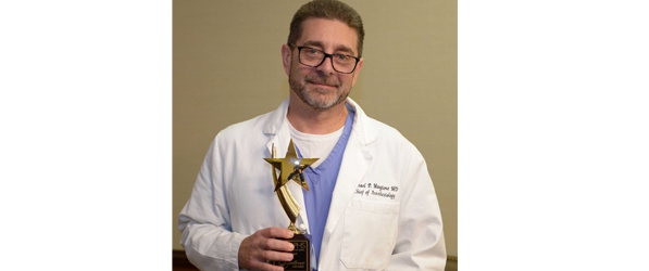 "Doctor Mangione posing with award"