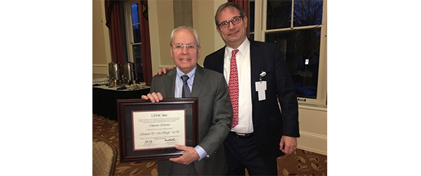 "Doctor McHugh posing with award"