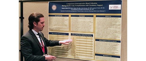 "Resident presenting in front of a poster"