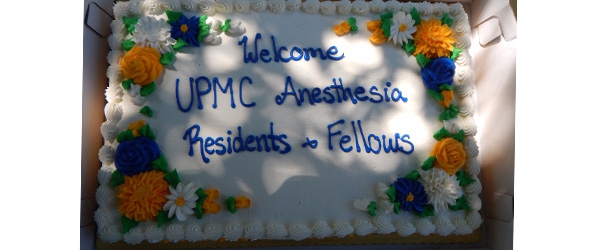 "A cake with the words Welcome UPMC Anesthesia Residents and Fellows in frosting"