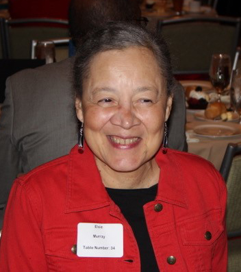 "Elsie Murray at a dinner event, smiling."
