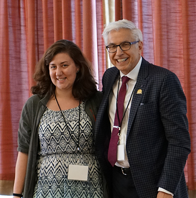 "Marta Wells and Doctor Kochanek pose in front of curtains"