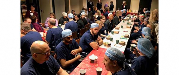 "A large group of CRNAs having breakfast at two long tables"