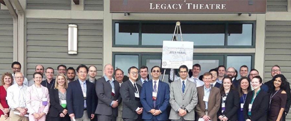 "A large group of department members pose for a group photo"