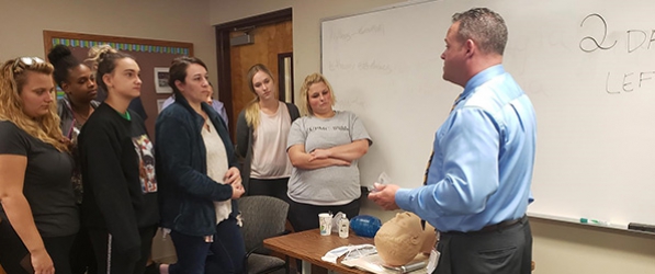 "Brett Fadgen giving a presentation to a group of nurses"