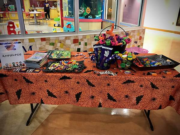 "A Halloween-themed table with toys and activities"