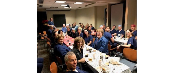 "A group of CRNAs sitting at tables"