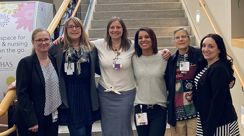 "Group of Magee Womens Hospital staff posing at foot of stairs"