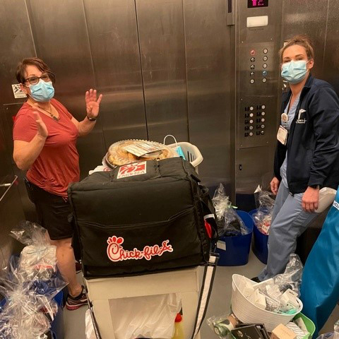 "Karen and Carley delivering food in an elevator"