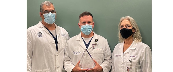 "Michael Jordan poses with award next to UPMC CRNA clinical directors"