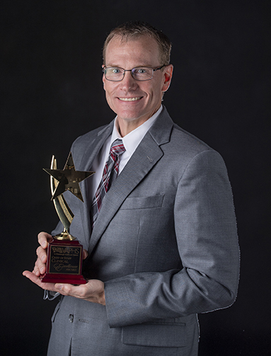 "Doctor Ibinson posing with award"