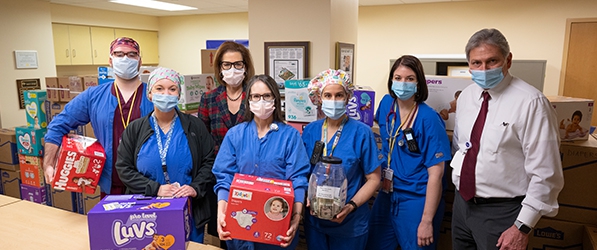 "CRNAs pose with donated items"