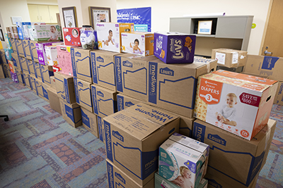 "A large room full of boxes of donated items"