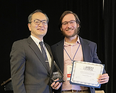 "Doctor Frabitore receiving award with Doctor Sakai"