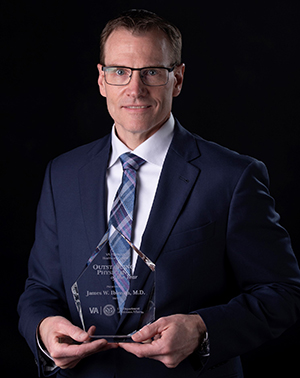 "Doctor Ibinson posing with an award"