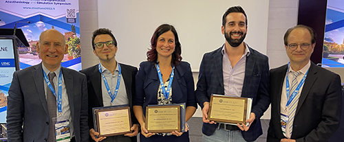 "Doctors pose with awards"