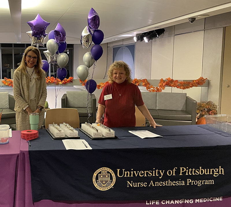 "Dr. Laurel Miner and Valerie Sabo from the Pitt Nurse Anesthesia Program welcomed attendees at the check-in table."