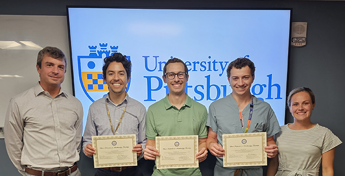 "Three residents pose with awards with residency program director Doctor Adams and associate director Doctor Ungerman"