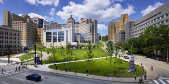 The outside of UPMC Presbyterian from across Fifth Ave