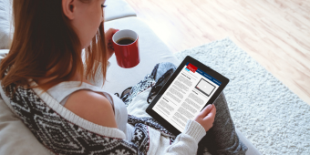 person reading news on a tablet