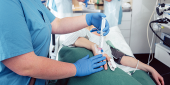 nurse giving anesthesia to a patient