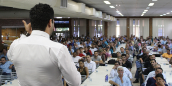 doctor lecturing in front of large audience