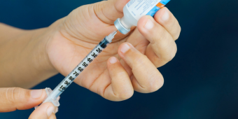 medical worker preparing syringe from injection