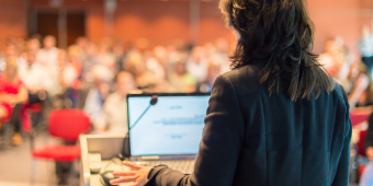 person presenting a lecture to an audience