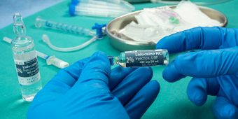 Photo of a doctor holding an ampule of lidocaine