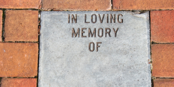 Photo featuring a memorial plaque that says "In Loving Memory of"