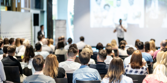 people listening to a presentation at a medical conference