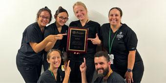 The Pediatric Sedation Service team at UPMC Children’s Hospital of Pittsburgh holding their center of excellence award plaque