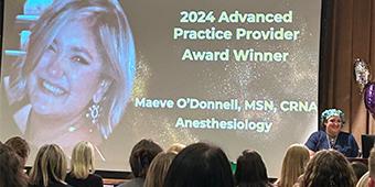 Maeve accepting her award in front of an audience