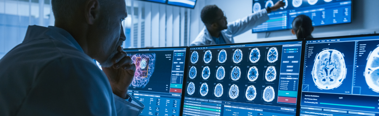 scientist reviewing CT brain scan images on a computer