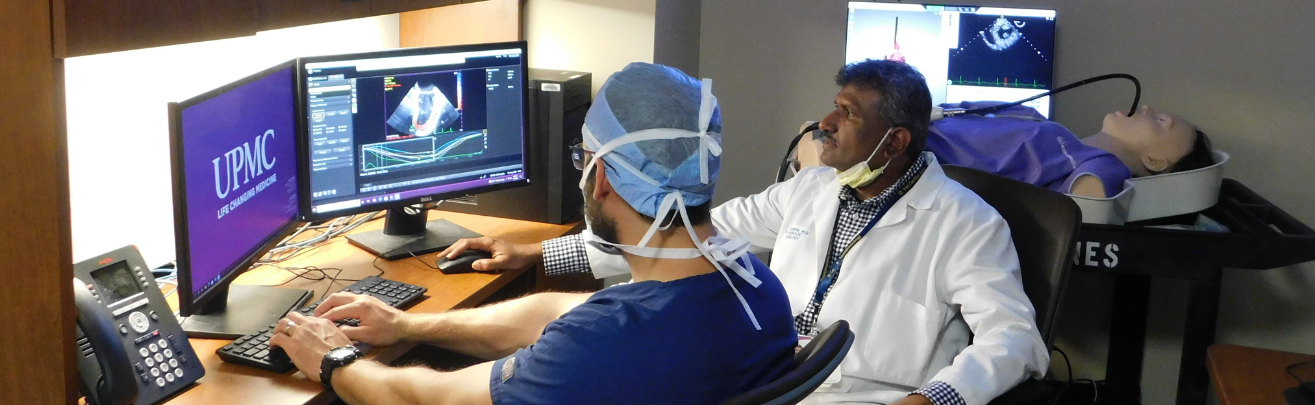 two physicians checking data on a computer