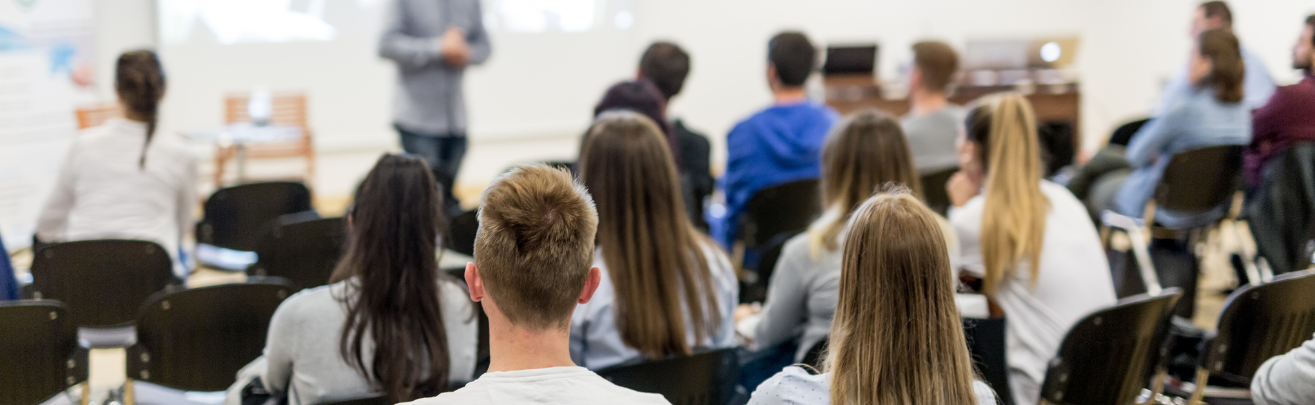 Slightly blurred photo of a speaker lecturing at a university