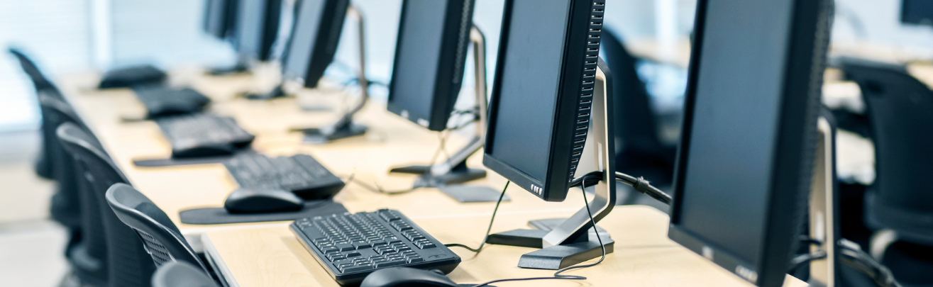 Photo of a few desktop computers on a desk